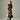 Woman holding a black Braun Büffel leather bucket bag styled with a brown minimalist outfit