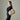 Woman wearing a beige Braun Büffel leather bucket bag over the shoulder with a casual minimalist outfit
