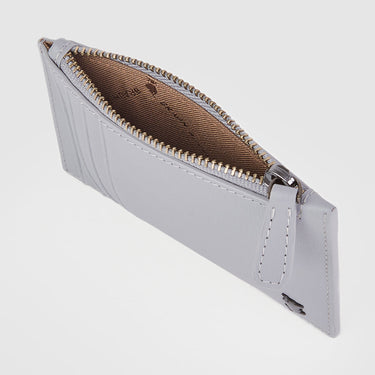 Angled top view of a grey Braun Büffel leather card holder showing zip compartment interior