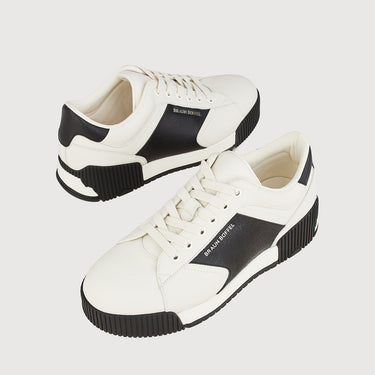 Braun Buffel white and black leather sneakers displayed in angled pair