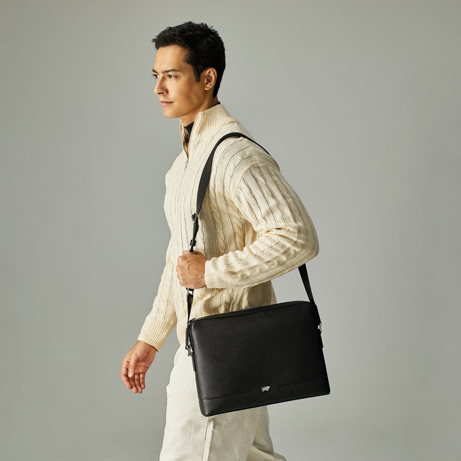 Model wearing Braun Büffel black leather crossbody bag