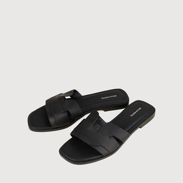 Pair of black leather sandals with crossover strap design by Braun Buffel